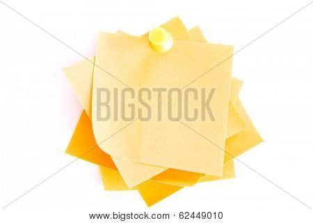 Yellow small memo attached with drawin pin. Isolated on white.