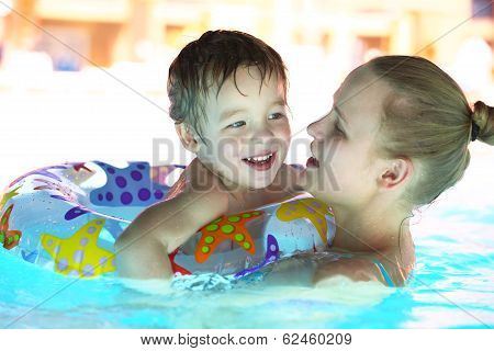 Mother and her son in the outdoor swimming pool