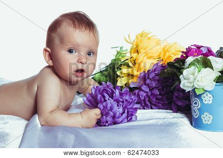 Baby with blue eyes lies in colors