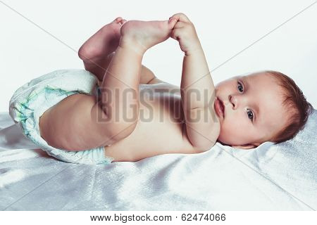 Babe with blue eyes is holding a bottle