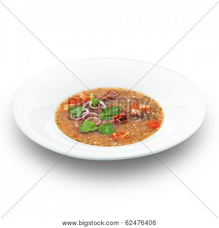 Traditional georgian hot tasty soup kharcho decorated with parsley. Isolated on white.