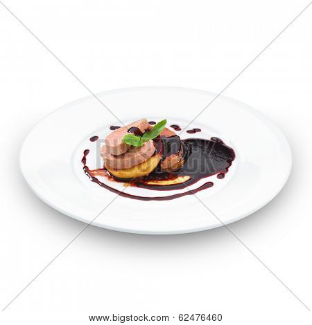 Gourmet foie gras served with red berry sauce and decorated with basil leaf. Isolated on white.