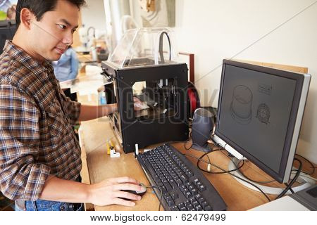Male Architect Using 3D Printer In Office