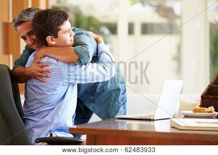 Father And Teenage Son Having A Hug