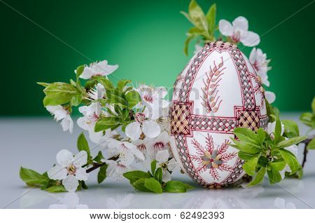 Beautiful red easter egg against green gackground