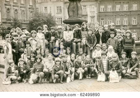 GOCZALKOWICE, POLAND, AUGUST 8, 1981: Vintage photo of group of classmates and teachers posing together during a school excursion