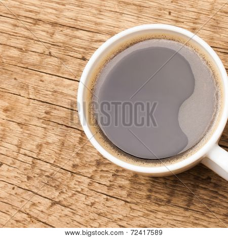 Coffee In White Ceramic Cup On Wooden Table