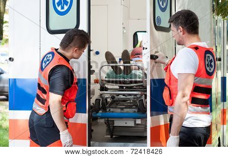 Woman Lying On Stretcher In Ambulance
