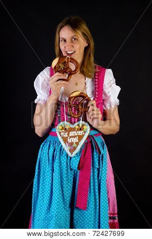 Woman In Dirndl Eating Pretzel