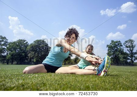 Two Young Girls Stetching Before A Jogging
