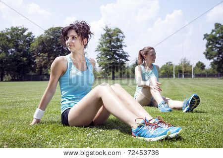 Two Young Girls Stetching Before A Jogging