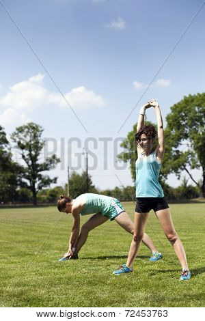 Two Young Girls Stetching Before A Jogging