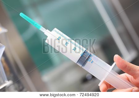 Large Syringe With A White Medicine In The Hands Of Nurse