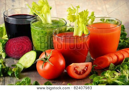 Glasses With Fresh Organic Vegetable Juices On Wooden Table