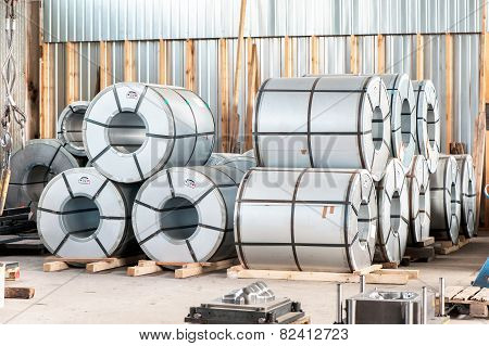 Bended Metal Sheet Rolls In Factory Warehouse. Metal Engineering.