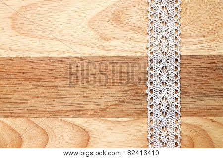 lace ribbon on wooden background