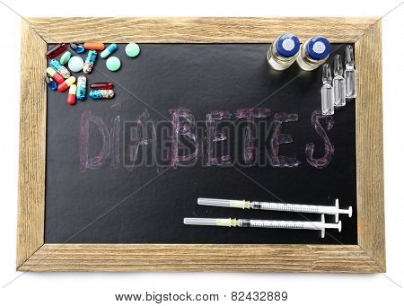 Blackboard medicines and word Diabetes isolated on white background