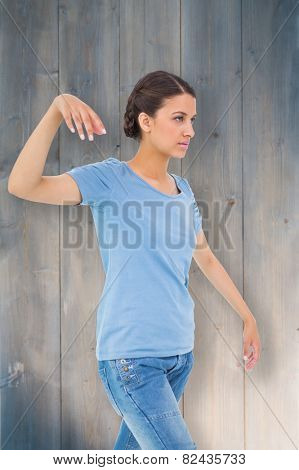 Powerless brunette against bleached wooden planks background