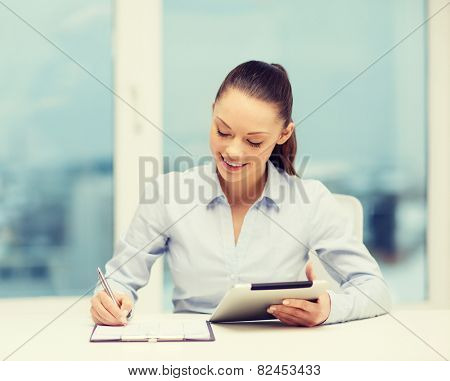 office, business, technology and internet concept - businesswoman with tablet pc and documents in office