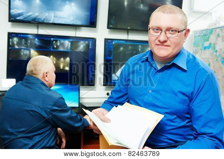 security executive chief in front of video monitoring surveillance security system