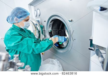 pharmaceutical factory woman worker operating tablet glazing production line at pharmacy industry manufacture factory