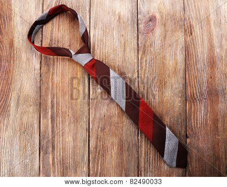 Stripped tie on wooden planks background