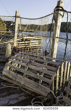 Old wooden lobster trap with fishing nets on a Newfoundland dock.