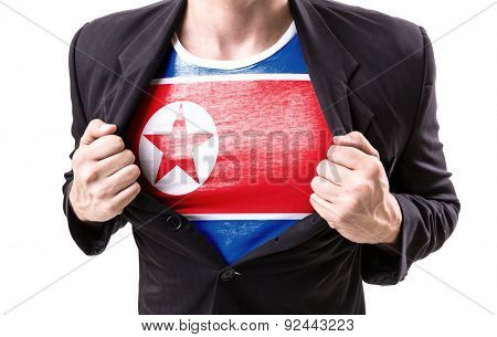 Businessman stretching suit with North Korea Flag on white background