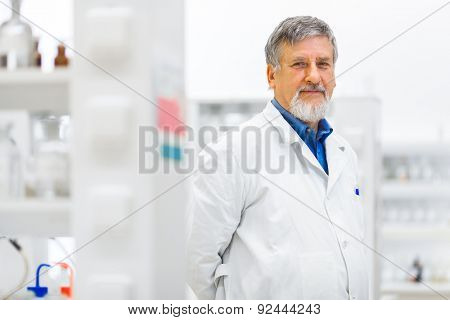 Senior male researcher carrying out scientific research in a lab (shallow DOF; color toned image)