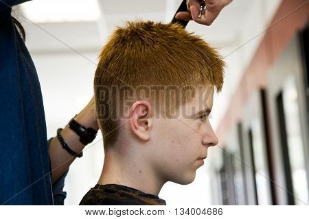 Smiling Young Boy With Red Hair At The Hairdresser