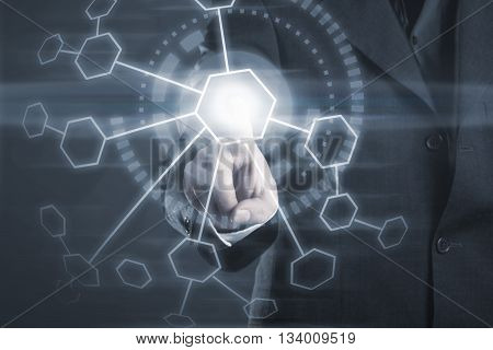 Businessman touching button on futuristic interface with copy space