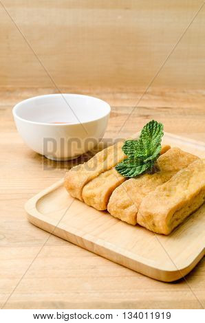 Fried Tofu In Wooden Plate With Sauce On Wooden Background