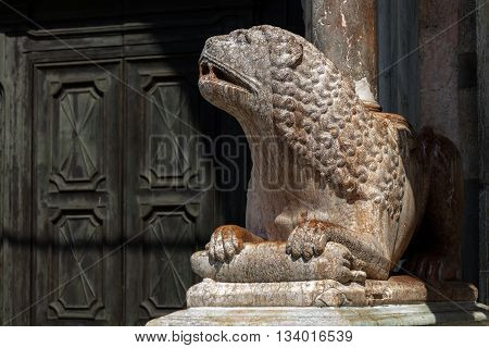 The columns of the Cremona's cathedral narthex stand on two lions in Verona marble. The right one is holding a bear in his paws.