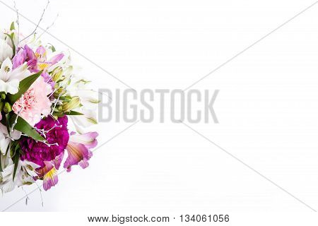 Bouquet from pink and purple gillyflowers and alstroemeria on white background top view
