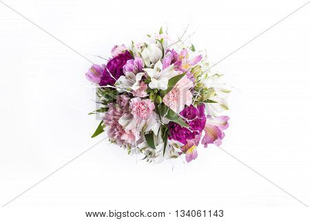Bouquet from pink and purple gillyflowers and alstroemeria on white background from the top