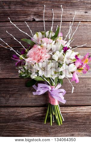 Summer bouquet from gillyflowers and alstroemeria on old wooden background