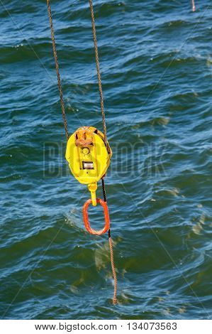 Yellow and Orange Turnbuckle Over Sea with cabler