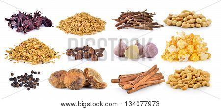 Dried figs, pepper corn, chili seeds, spice cloves, rice grains, Dried okra, cashew nuts, peanuts, garlic, popcorn and cinnamon on a white background