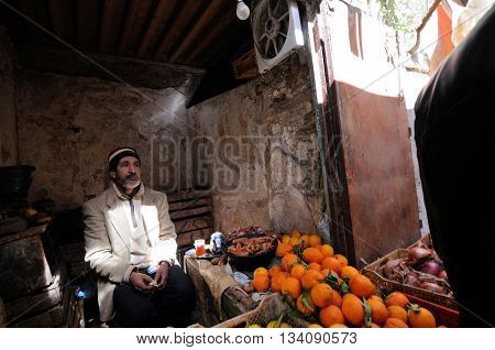 FES - MARCH 10: Unknown man trades a fruits in a Market (souk) in a city Fes in Morocco. The market is one of the most important attractions of the city. March 10, 2012 Fes, Morocco.