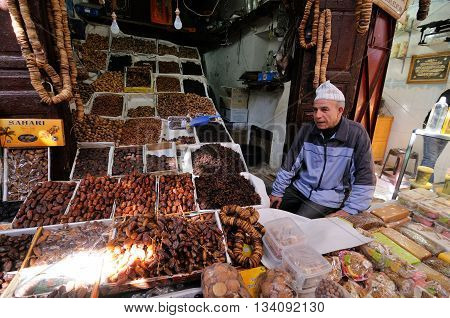 FES - MARCH 10: Unknown man trades a dried Fruits in a Market (souk) in a city Fes in Morocco. The market is one of the most important attractions of the city. March 10, 2012 Fes, Morocco.