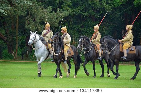 Silsoe, Bedfordshire, England - May 30, 2016:  Four members of the Punjab Lancers in World War One uniform riding horses.