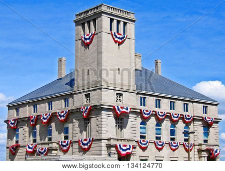Red white and blue buntings blown by the breeze festoon a building in celebration of America. Sault Ste. Marie Michigan.