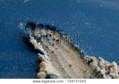 Photo of Footprints in the sand in black and white sind, Costa Rica.
