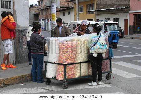 Cajamarca Peru - June 11 2016: Man sells puffed sweetened cereal snacks from a cart on the streets of Cajamarca Peru on June 11 2016
