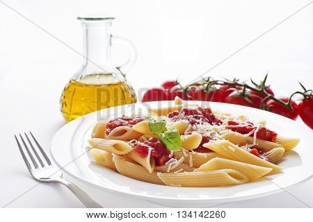 Plate of penne pasta with tomato sauce and parmesan cheese.