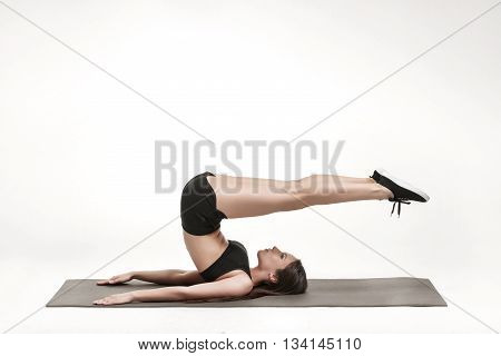 Portrait of young attractive woman doing exercises. Brunette with fit body on yoga mat. Healthy lifestyle and sports concept. Series of exercise poses.