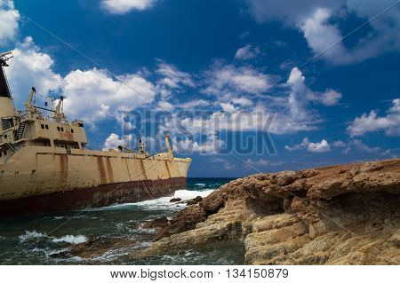 Shipwrecked boat near the rocky shore aground. Mediterranean Sea near Paphos. Cyprus