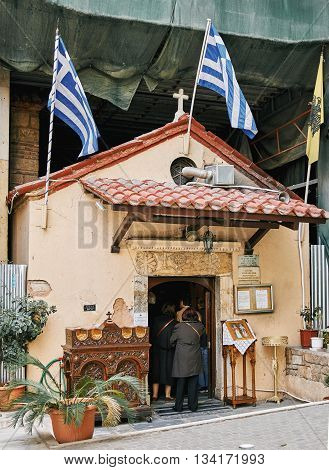Athens Greece - March 27 2016: People enetering in small church in the center of Athens for the morning pray