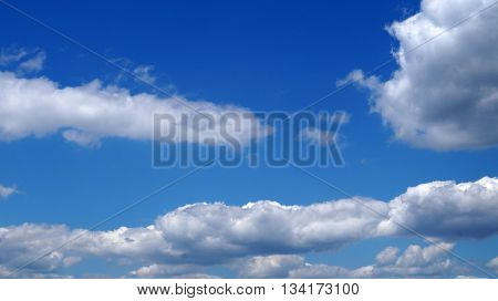 Blue beautiful sky with white fluffy clouds