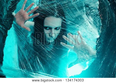 Woman sitting in big cocoon. Creative photoshoot
